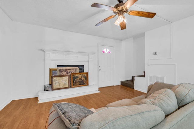 living room with ceiling fan and light hardwood / wood-style floors