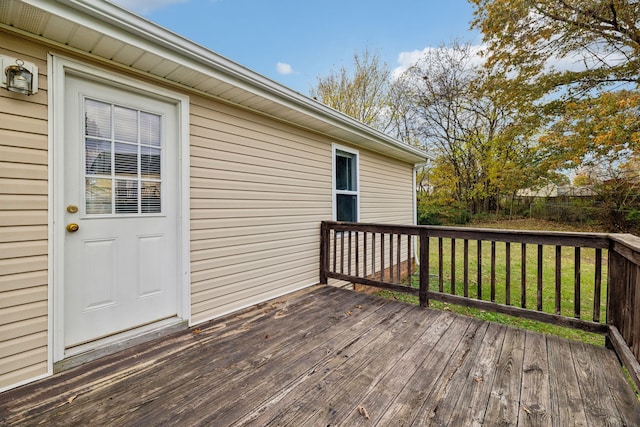 wooden deck with a lawn