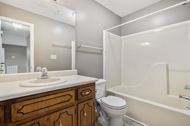 full bathroom featuring vanity, toilet, a textured ceiling, and bathing tub / shower combination