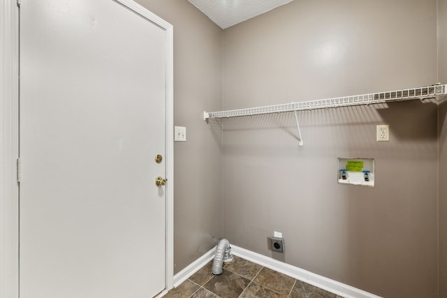 washroom featuring washer hookup, a textured ceiling, and electric dryer hookup