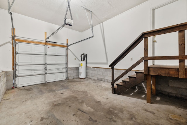 garage with water heater and a garage door opener