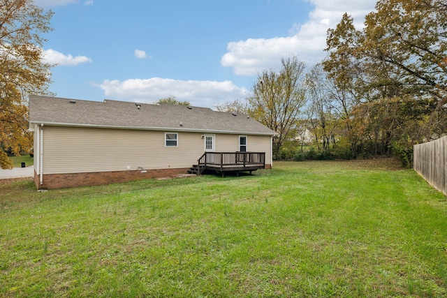 rear view of property featuring a yard and a deck