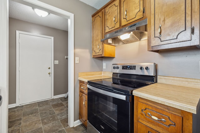 kitchen featuring stainless steel electric range and a textured ceiling