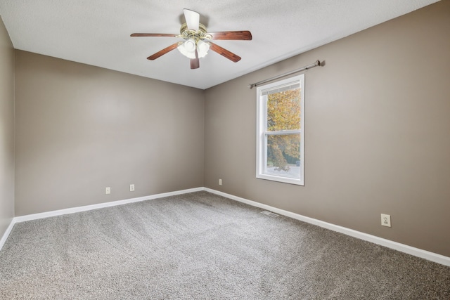 spare room with carpet flooring, a textured ceiling, and ceiling fan