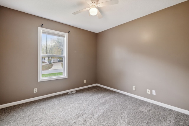 spare room featuring carpet floors and ceiling fan