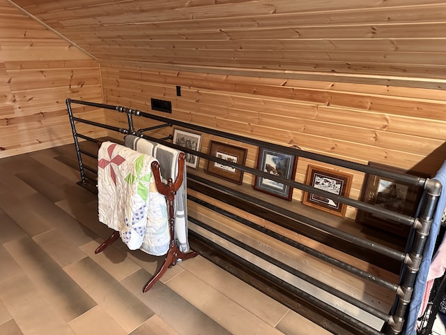 interior space with wood walls, wooden ceiling, and vaulted ceiling