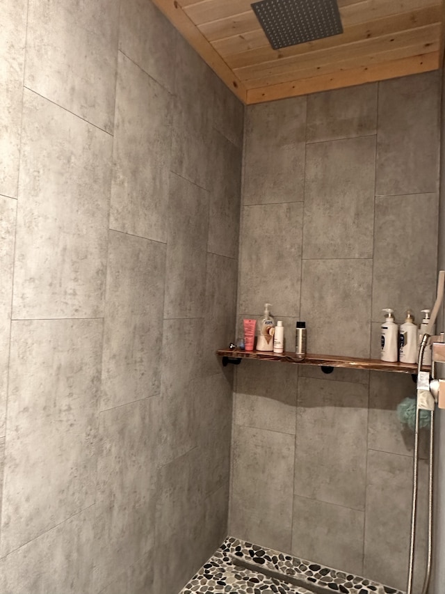 bathroom featuring wood ceiling and tiled shower