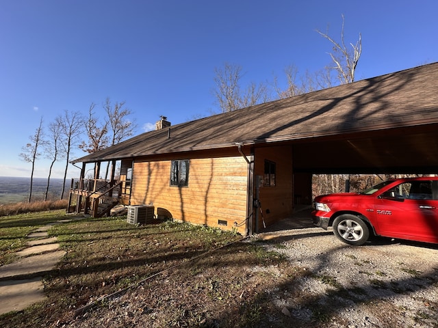 view of property exterior with a carport and cooling unit