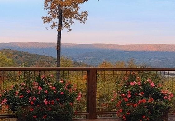 balcony at dusk featuring a mountain view