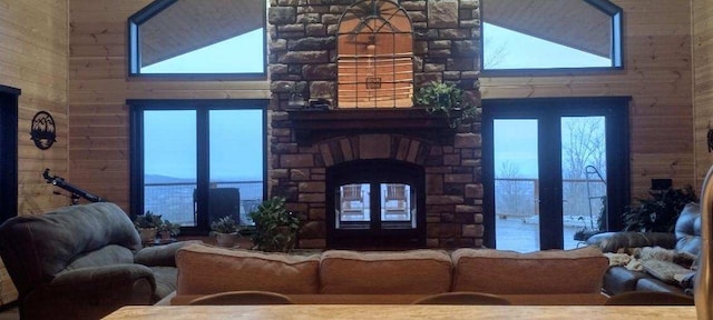 living room featuring wooden walls and vaulted ceiling