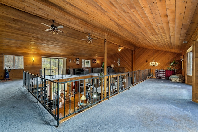 corridor featuring wooden walls, carpet, wood ceiling, and lofted ceiling