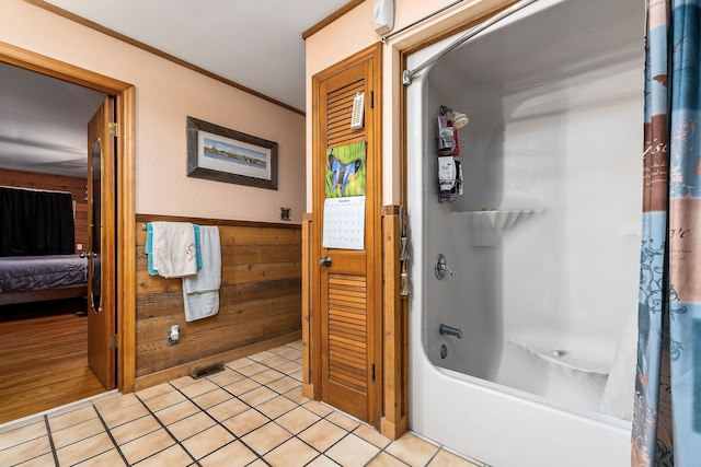 bathroom featuring wooden walls, tile patterned floors, shower / bathtub combination with curtain, and crown molding