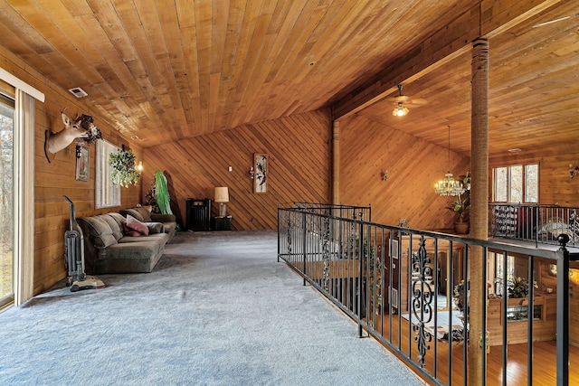 hall with lofted ceiling with beams, an inviting chandelier, and wooden ceiling