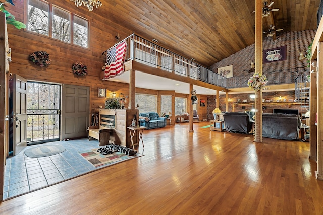 interior space with ceiling fan, hardwood / wood-style floors, high vaulted ceiling, and wood ceiling