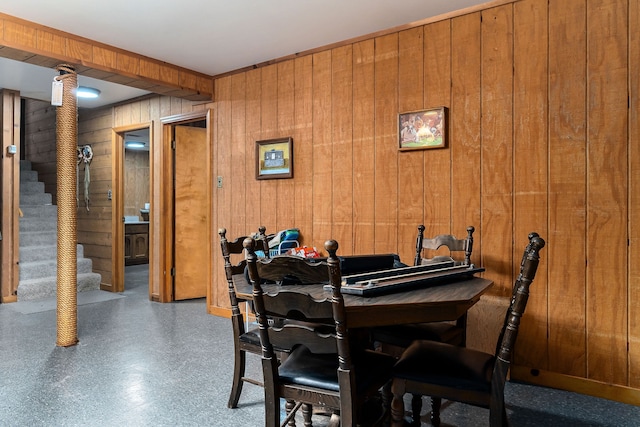 dining space with wood walls