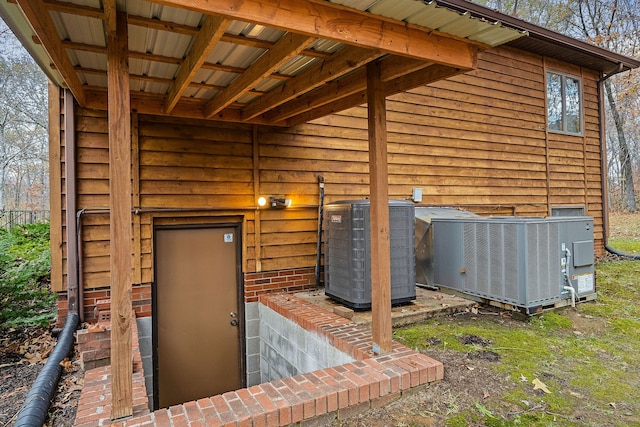 view of exterior entry featuring central AC unit