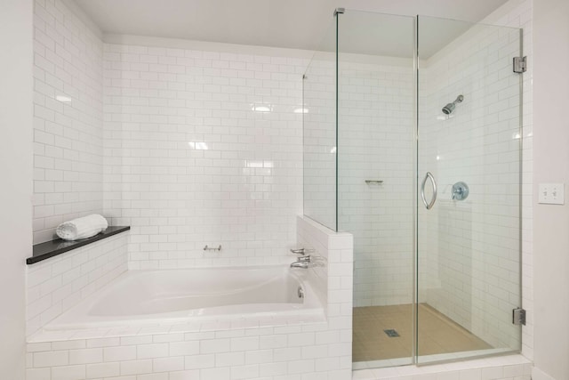 bathroom featuring independent shower and bath