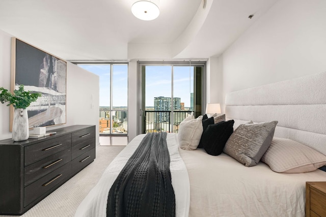 bedroom featuring light carpet and access to outside