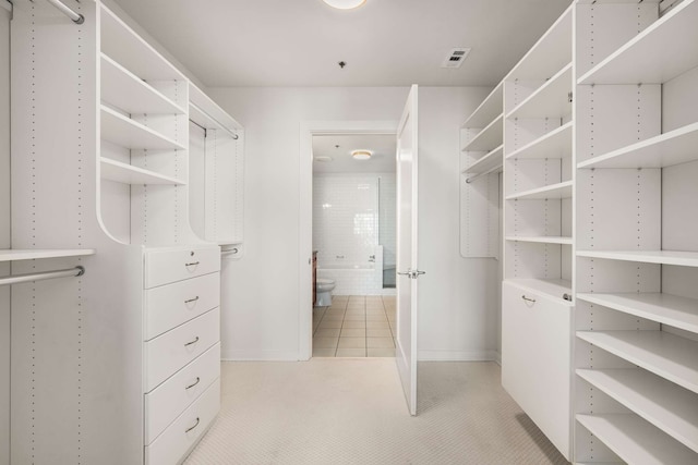 spacious closet featuring light tile patterned floors