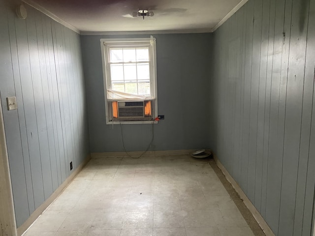 unfurnished room with cooling unit, crown molding, and wooden walls