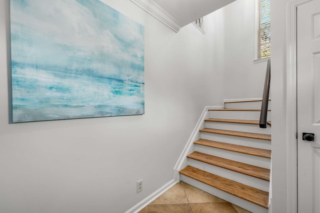 stairway featuring tile patterned flooring and ornamental molding