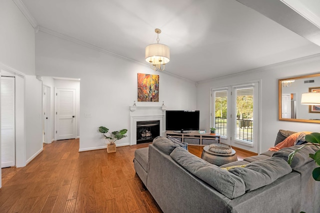 living room with wood-type flooring and ornamental molding