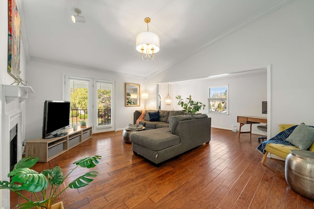 living room featuring lofted ceiling, dark hardwood / wood-style flooring, plenty of natural light, and ornamental molding