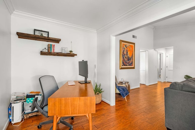 office space featuring hardwood / wood-style floors and ornamental molding