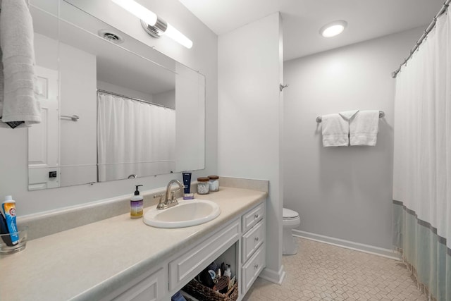 bathroom featuring toilet, vanity, and tile patterned floors