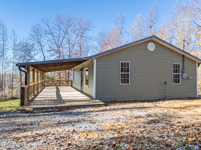 view of property exterior featuring a wooden deck