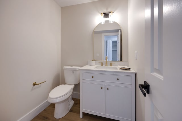 bathroom featuring vanity, toilet, and wood-type flooring