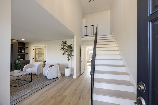 staircase with hardwood / wood-style flooring