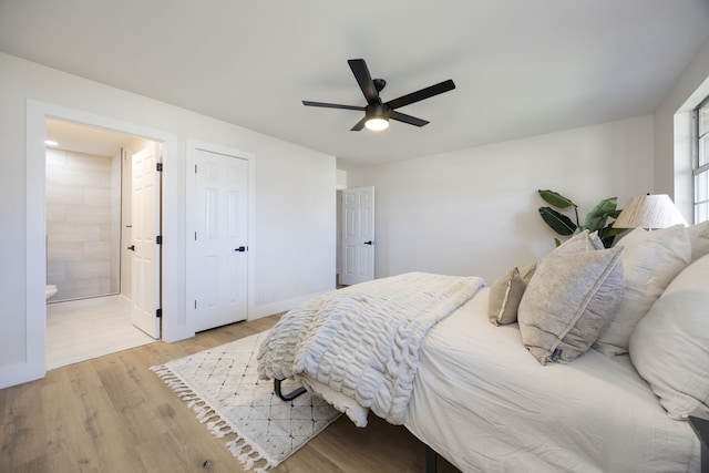 bedroom featuring ceiling fan, light wood-type flooring, and ensuite bathroom