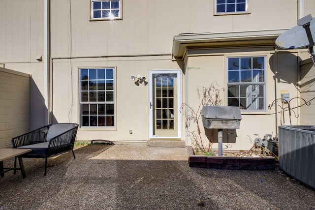 entrance to property with central AC and a patio area