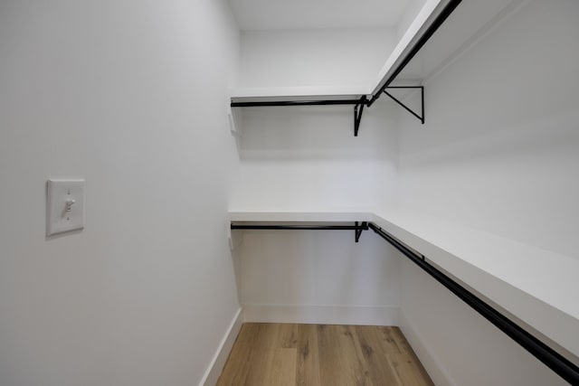 spacious closet featuring hardwood / wood-style floors