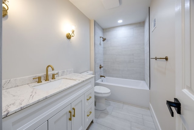 full bathroom featuring vanity, toilet, and tiled shower / bath combo