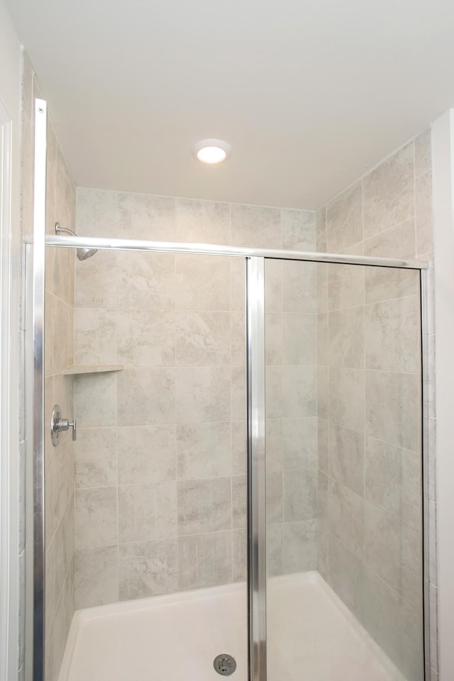 bathroom with a shower with shower door