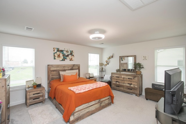 carpeted bedroom featuring multiple windows