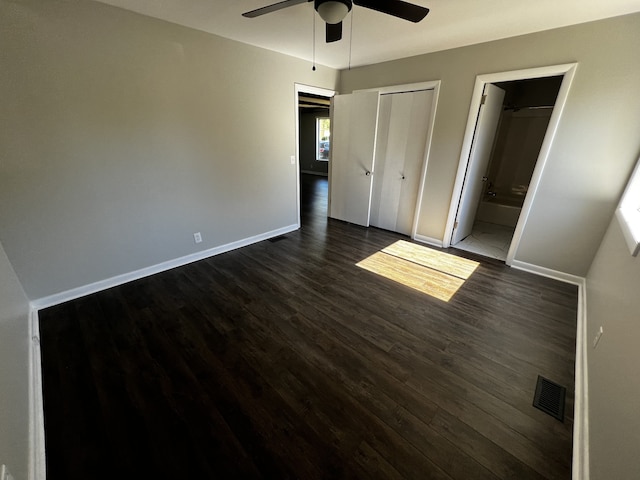 unfurnished bedroom with ensuite bath, ceiling fan, and dark hardwood / wood-style floors