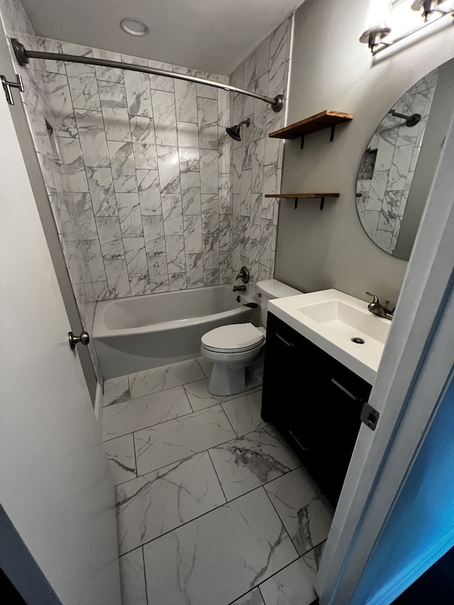 full bathroom featuring vanity, tiled shower / bath combo, and toilet