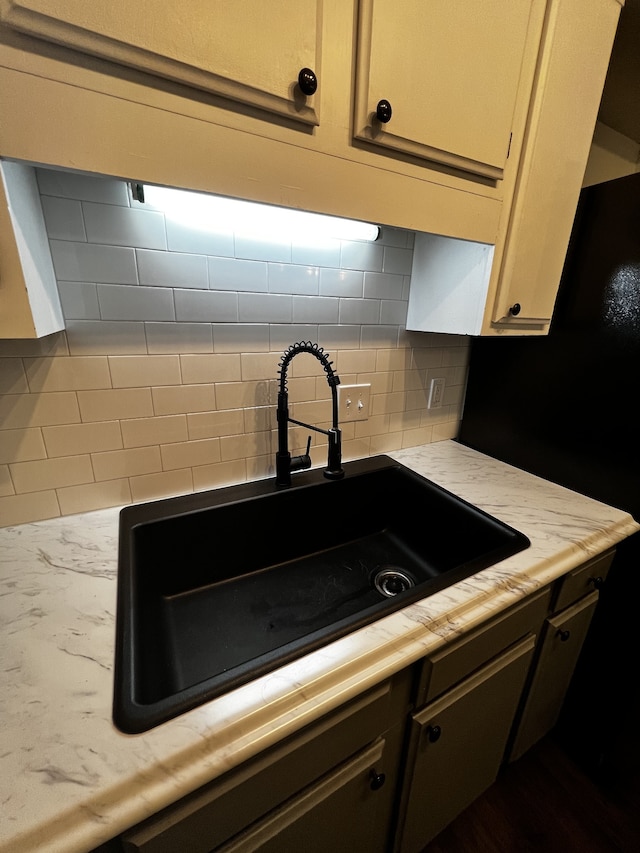 kitchen featuring tasteful backsplash and sink