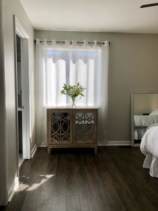 bedroom with dark hardwood / wood-style floors