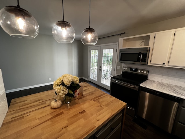 kitchen with white cabinets, decorative light fixtures, appliances with stainless steel finishes, and french doors