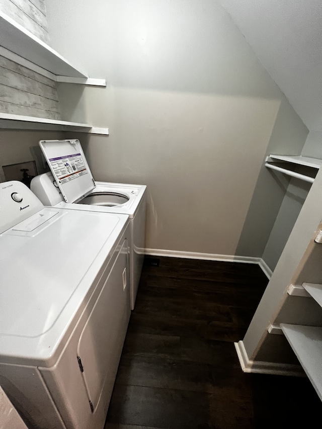 clothes washing area featuring washing machine and dryer and dark hardwood / wood-style floors