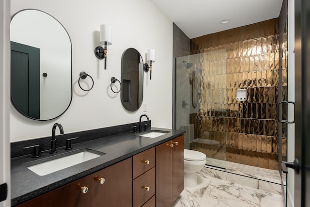 bathroom featuring vanity, toilet, and a shower with shower door