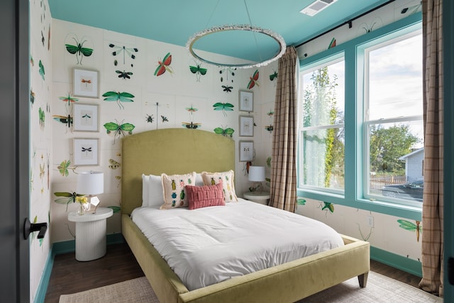 bedroom featuring wood-type flooring and multiple windows