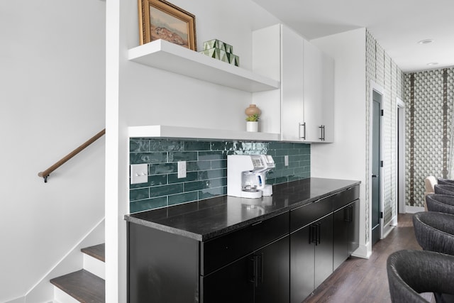 kitchen with backsplash, white cabinets, and dark wood-type flooring