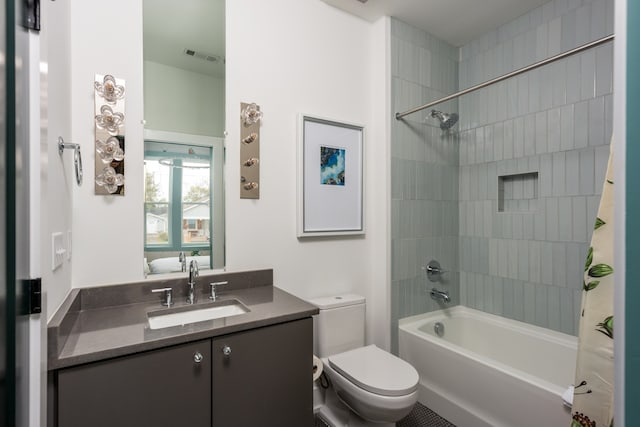 full bathroom featuring shower / bath combo, vanity, and toilet