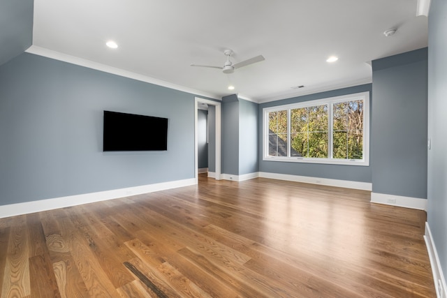 unfurnished living room featuring wood-type flooring, ceiling fan, and ornamental molding