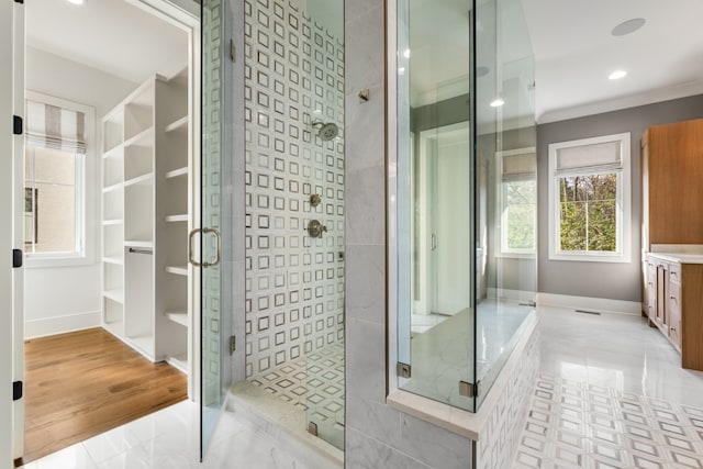 bathroom featuring wood-type flooring, crown molding, and walk in shower